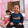 toddler, child, doll, bed, pink_canopy, blue_sweater, knitted_overalls, socks, indoor, smiling, happy, portrait, person, furniture, door, room, hair, face, toy, seated