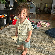 Tony joined the competition — help win amazing prizes! toddler, child, indoor, carpet, barefoot, smiling, messy_hair, shorts, shirt, living_room, staircase, baby_gate, toy, furniture, home, person, floor, candid, happy, casual