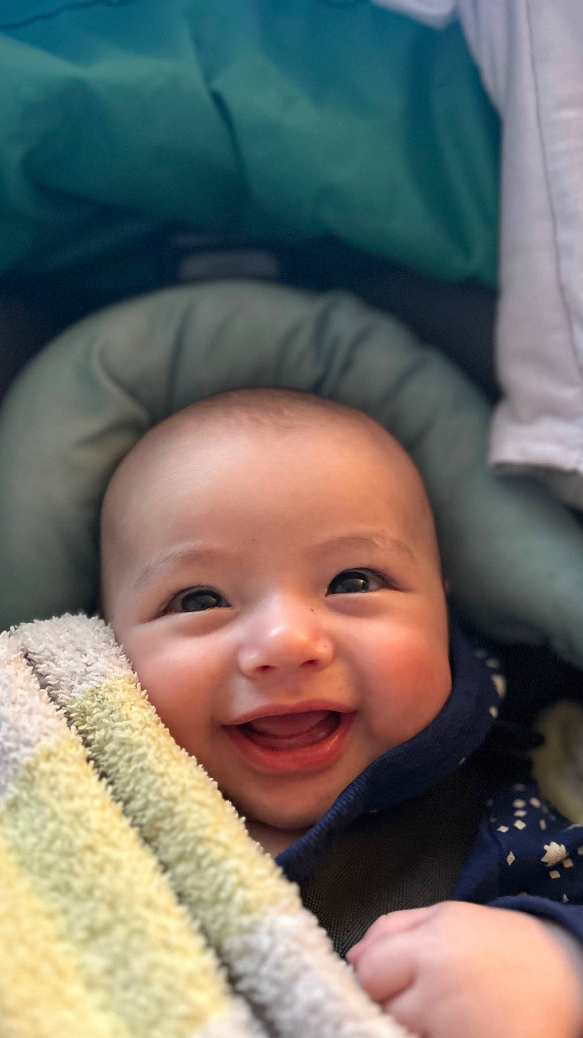 Knox is registered to the contest to win money with this photo: baby, cheek, chin, comfort, eye, eyebrow, facial_expression, finger, flash_photography, gesture, happy, head, iris, lip, mouth, nose, person, skin, smile, textile