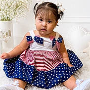 Cielo is registered to the contest to win money with this photo: toddler, child, girl, dress, pigtails, bows, stars, stripes, red, white, blue, sitting, indoor, portrait, cute, flower, decor, soft, curious, baby
