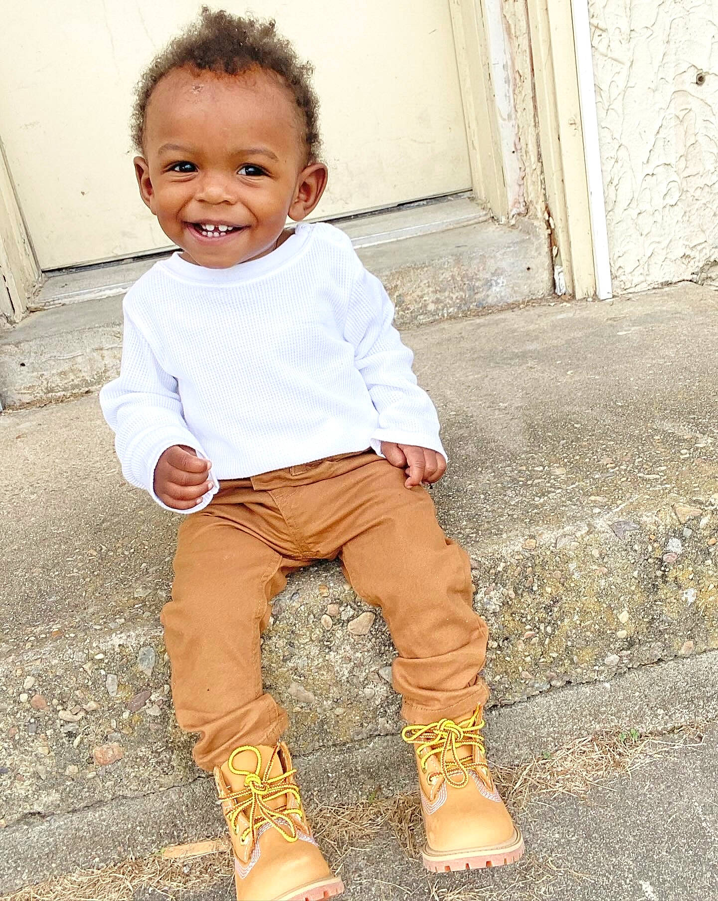 Chance joined the competition — help win amazing prizes! baby_toddler_clothing, child, denim, dress, foot, happy, human_leg, joy, leg, pattern, people_in_nature, person, shoe, sitting, skin, sleeve, smile, soil, standing, t_shirt