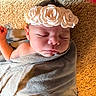 Evelynn is registered to the contest to win money with this photo: baby, bedding, blanket, carpet, child, closed_eyes, cozy, cute, face, flower_crown, headband, indoors, infant, newborn, peaceful, photography, portrait, resting, sleeping, swaddled