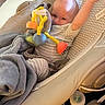 Wyatt is registered to the contest to win money with this photo: baby, infant, baby_rocker, toy, stuffed_animal, blanket, bottle, smiling, waving, clothing, child, indoor, comfort, baby_seat, playtime, cute, person, relaxing, happy, home