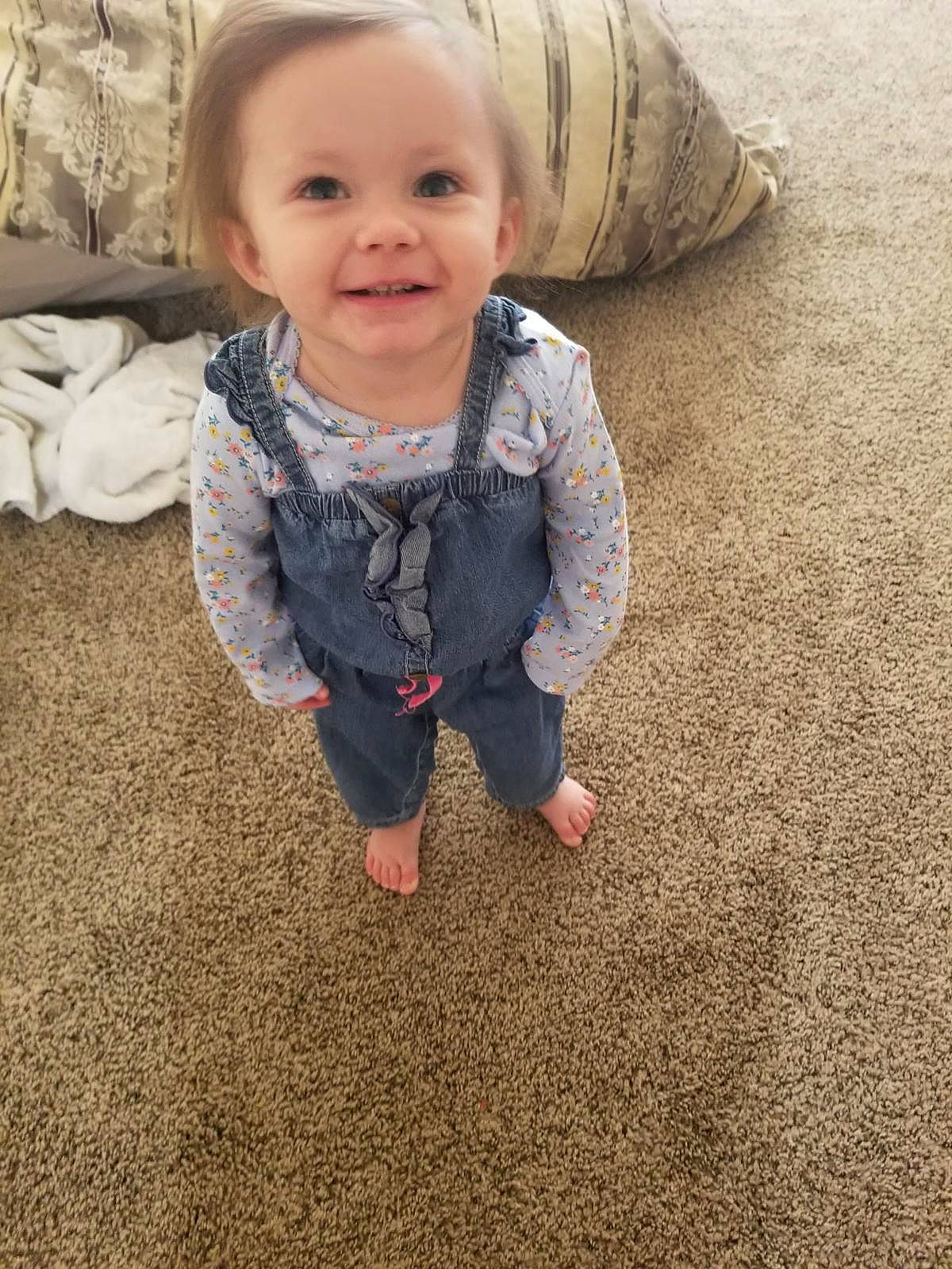 Emmy is registered to the contest to win money with this photo: baby, baby_toddler_clothing, cheek, child, comfort, eye, flooring, fun, grass, happy, iris, joy, nose, people_in_nature, person, sand, skin, sleeve, smile, soil