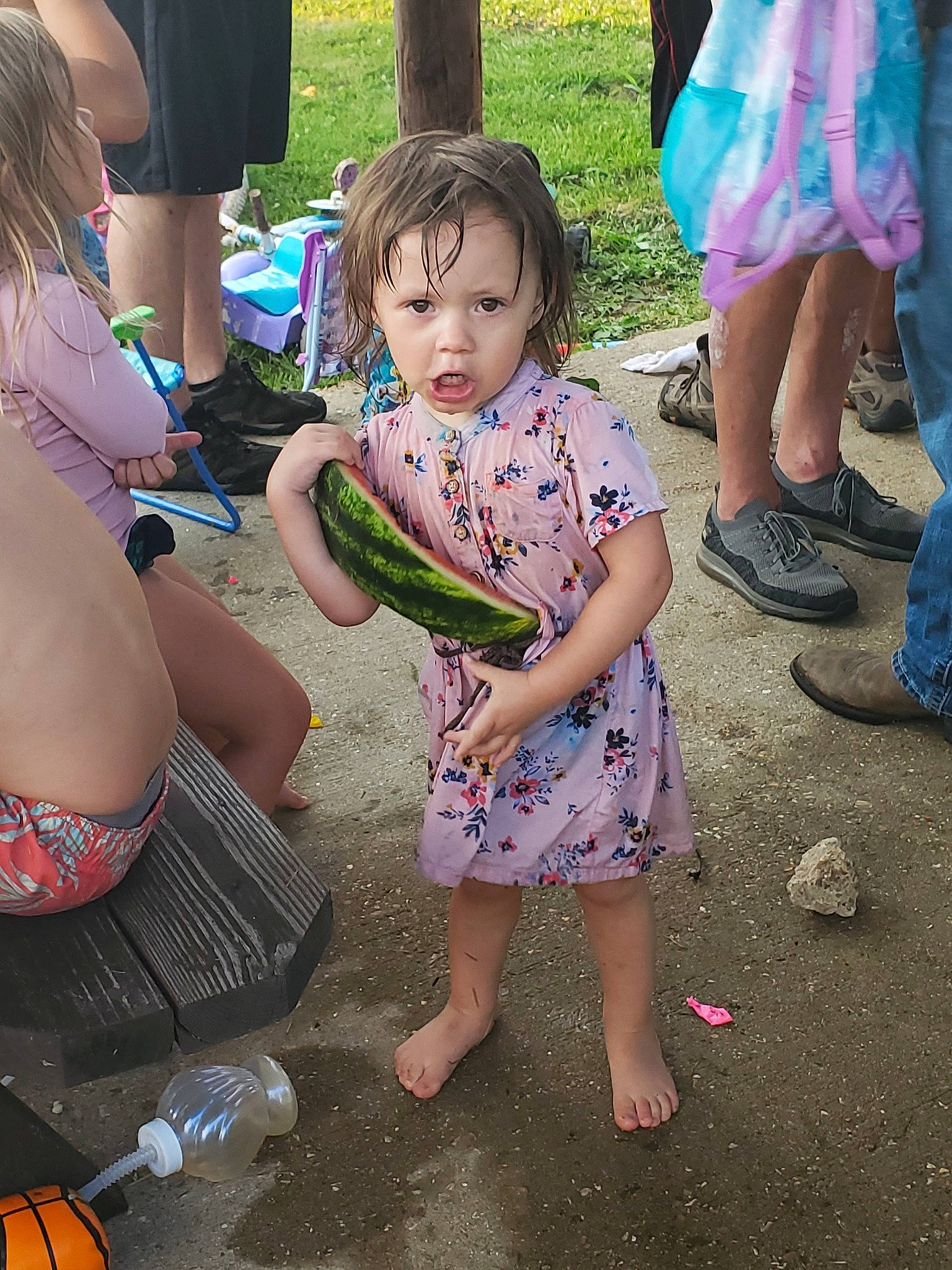 Emmy is registered to the contest to win money with this photo: child, flip_flops, footwear, fun, grass, green, happy, human_body, joint, leg, leisure, person, photograph, pink, sharing, shoe, shorts, sneakers, summer, thigh