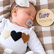 Lila joined the competition — help win amazing prizes! baby, infant, sleeping, pacifier, bow, white_bow, onesie, hearts, blanket, checkered_blanket, portrait, close_up, indoor, cozy, milestone, two_months, headband, peaceful, child, baby_photography