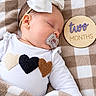 baby, infant, sleeping, pacifier, bow, white_bow, onesie, hearts, blanket, checkered_blanket, portrait, close_up, indoor, cozy, milestone, two_months, headband, peaceful, child, baby_photography