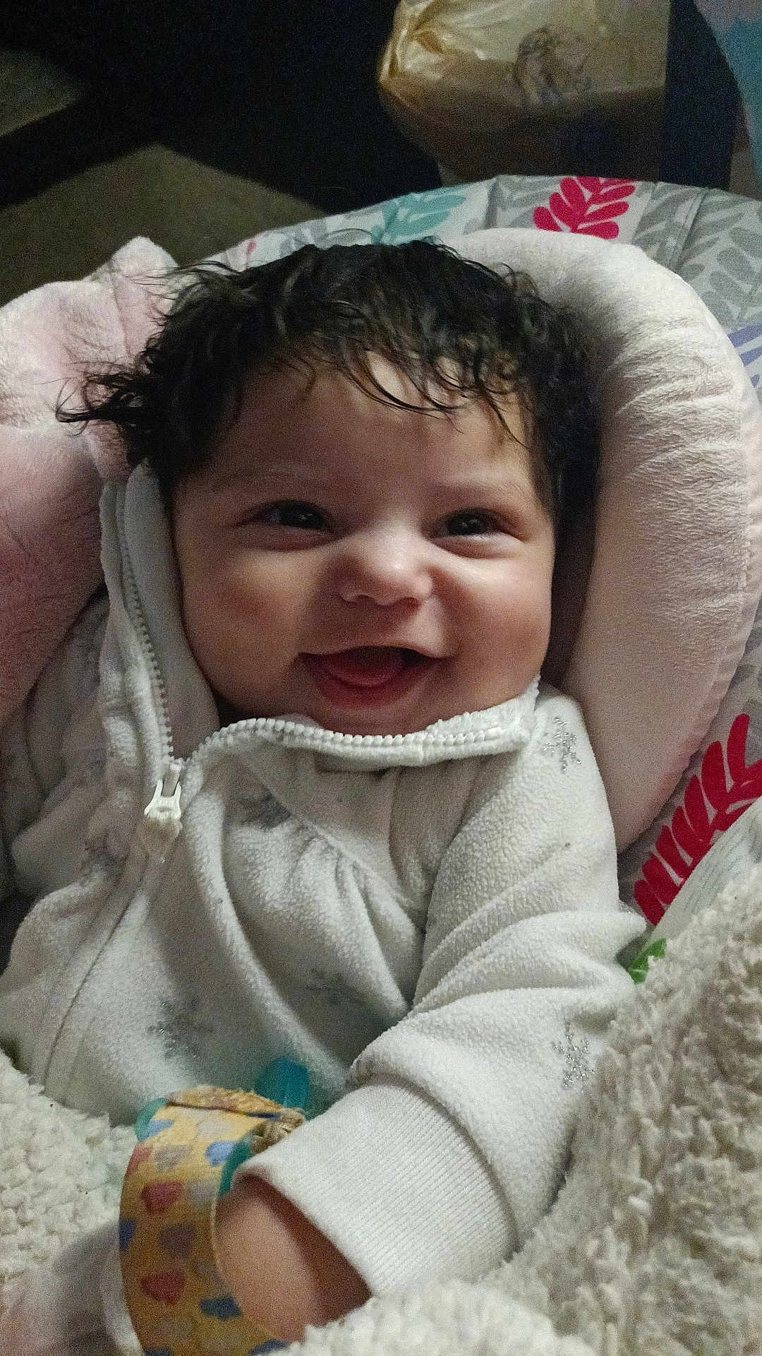 Chantelle is registered to the contest to win money with this photo: baby, smiling, infant, cozy, white_outfit, snowflake_pattern, curly_hair, baby_seat, blanket, happy, cute, child, indoors, portrait, soft_texture, warm, closeup, face, young_child, comfort