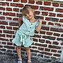 élyna a rejoint le concours — aidez-le/la à gagner de superbes lots ! brick_wall, casual, child, clothing, cute, expression, fashion, girl, hair, outdoor, person, playful, posing, sandals, shorts, smiling, standing, summer, top, young
