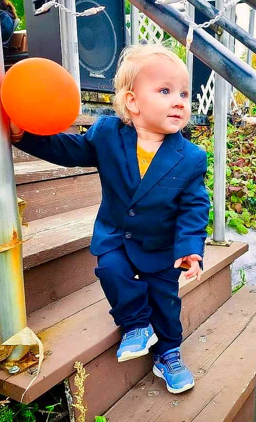 Aiden is registered to the contest to win money with this photo: baby_toddler_clothing, ball, blue, child, denim, electric_blue, formal_wear, fun, grass, happy, leisure, orange, person, sitting, sleeve, snapshot, standing, suit, toddler, wood