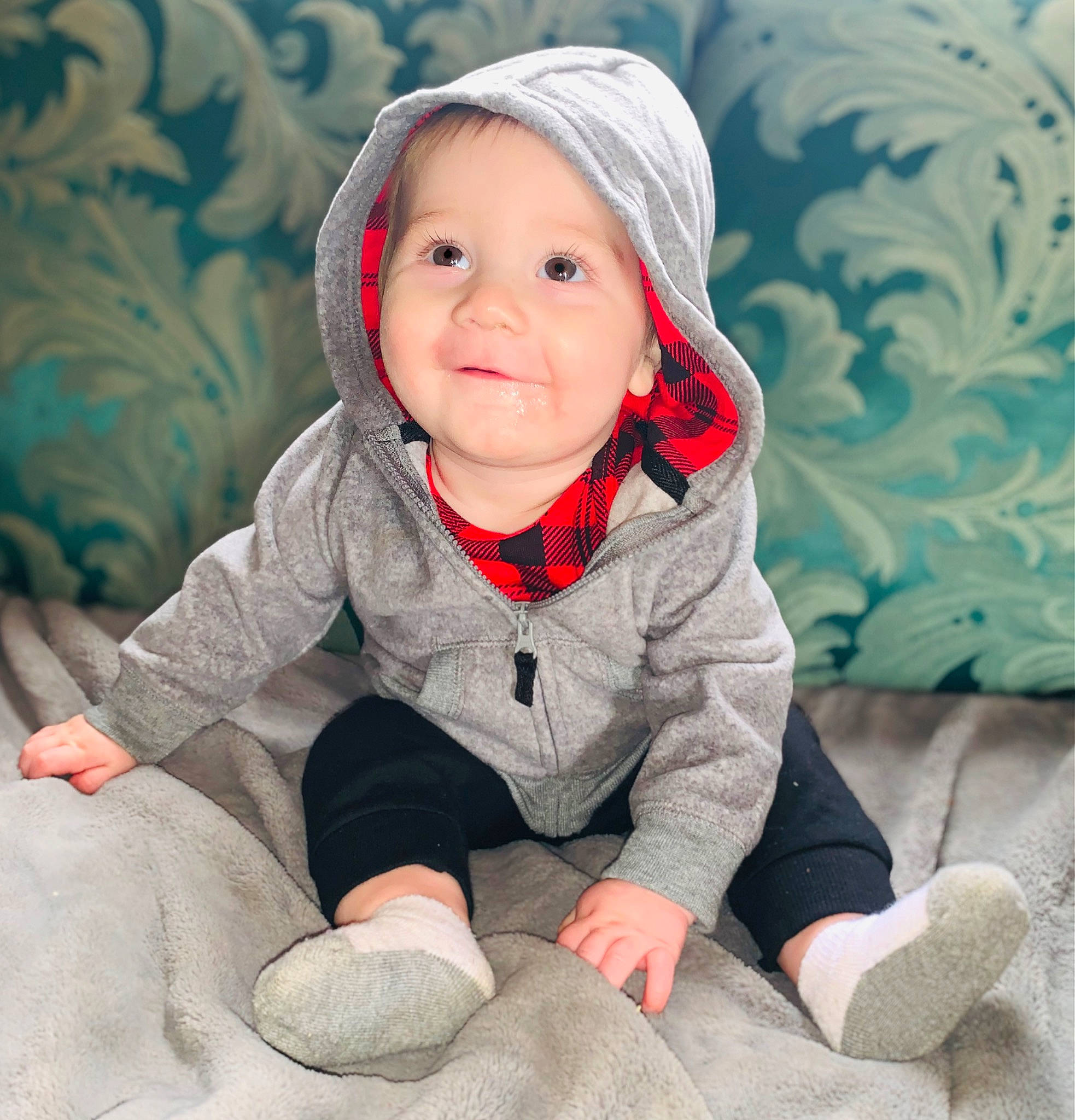 Deklan joined the competition — help win amazing prizes! baby, baby_toddler_clothing, cap, cheek, child, comfort, face, flooring, fun, happy, head, headwear, linens, person, plant, product, sitting, skin, sleeve, smile