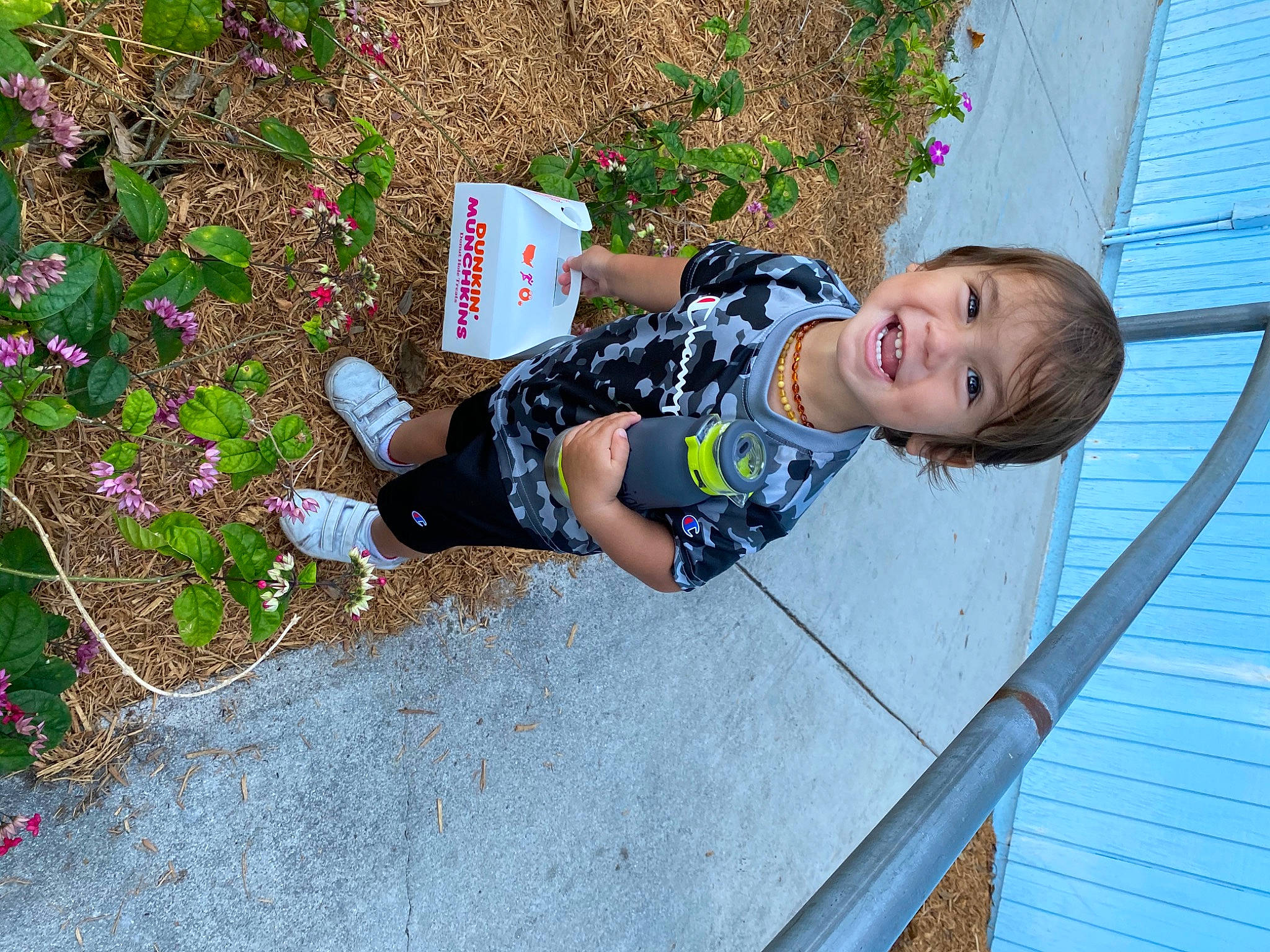 Jahsiah is registered to the contest to win money with this photo: baby_toddler_clothing, child, flower, fun, grass, groundcover, joy, leisure, pattern, people_in_nature, person, plant, recreation, sandal, shrub, sidewalk, smile, soil, thigh, toddler