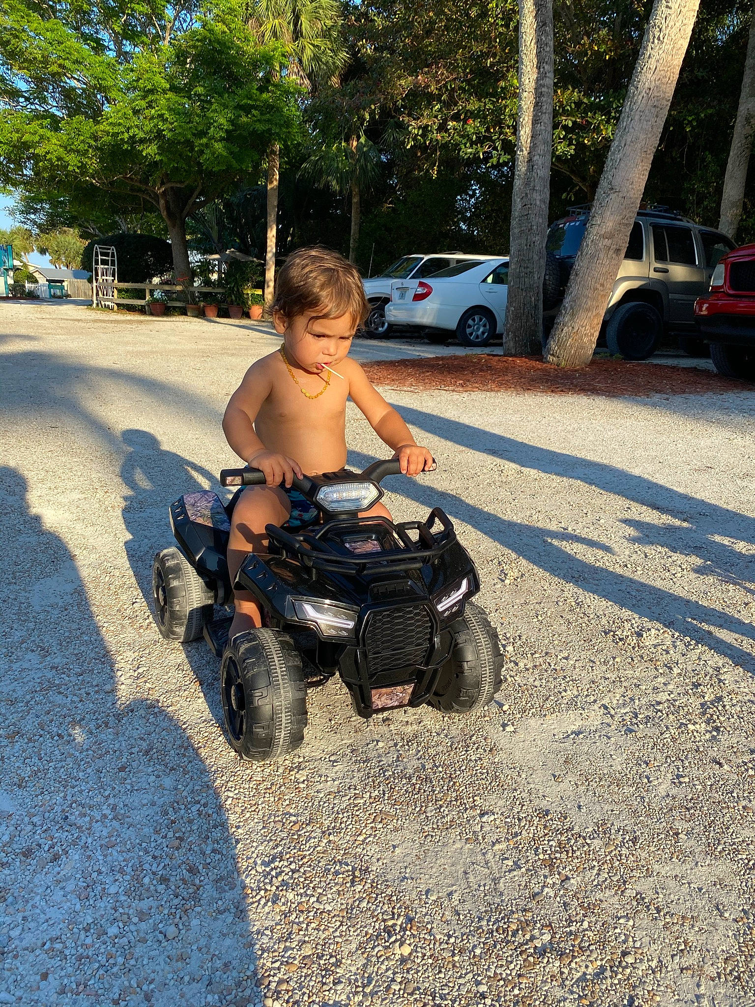 Jahsiah is registered to the contest to win money with this photo: asphalt, automotive_tire, baby, car, fun, grass, leg, leisure, person, plant, recreation, road_surface, rolling, shorts, tire, toddler, toy, tree, vehicle, wheel