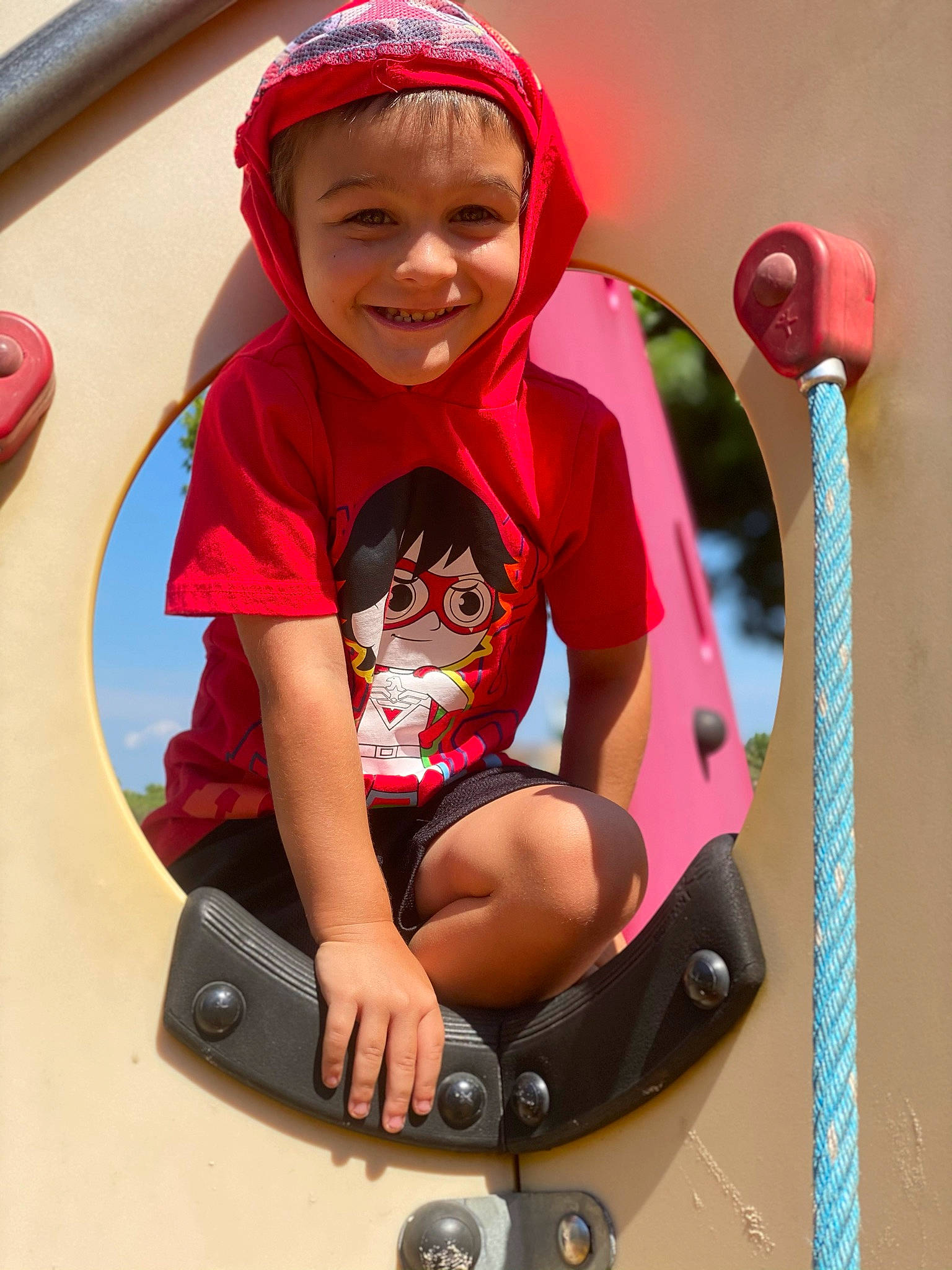 Justice is registered to the contest to win money with this photo: arm, baby, baby_toddler_clothing, cap, child, eye, face, fun, happy, head, headwear, human_body, joy, leisure, magenta, person, pink, product, red, riding_toy