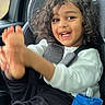 black_pants, car_interior, car_seat, child, clothing, curly_hair, expression, feet, hair, happy, indoor, person, playful, portrait, seat, seatbelt, smile, water_bottle, white_shirt, window