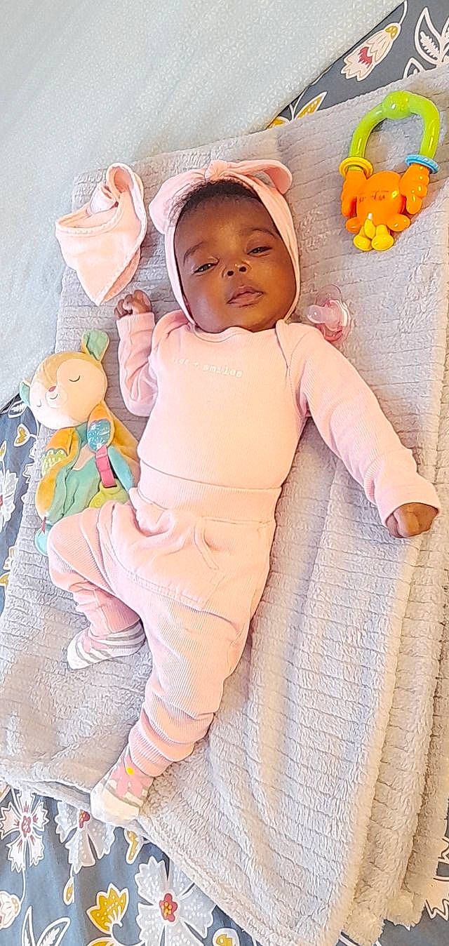 Destiny participe au concours pour gagner de l'argent avec cette photo : baby, baby_products, baby_safety, baby_sleeping, baby_toddler_clothing, baby_toys, cap, cheek, child, comfort, eye, happy, head, linens, person, pink, room, skin, sleeve, textile