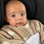 Nova-Rose is registered to the contest to win money with this photo: baby, infant, face, eyes, sweater, heart_pattern, blanket, cushion, seated, clothing, cute, skin, hand, portrait, child, young, indoors, comfort, warm, expression