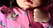 Kenleigh French is registered to the contest to win money with this photo: baby, child, close_up, clothing, cute, dark_background, disney, eyes, face, fist, floral_pattern, indoor, infant, lying_down, minnie_mouse, mouth, photography, pink_onesie, portrait, textile
