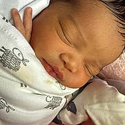 Rayelle is registered to the contest to win money with this photo: newborn, baby, sleeping, wrapped, blanket, infant, closeup, peaceful, tiny_hand, face, soft, cute, child, indoors, comfort, rest, skin, head, clothing, person