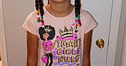 Laila is registered to the contest to win money with this photo: child, girl, smiling, standing, glasses, braided_hair, beads, tshirt, jeans, indoor, door, bracelets, hair_ties, wood_floor, thermostat, casual_clothing, portrait, happy, person, home