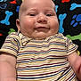 Julius joined the competition — help win amazing prizes! baby, blanket, bones, child, closeup, clothing, cute, fabric, face, happy, indoor, infant, pattern, paw_prints, person, portrait, skin, smiling, striped_shirt, young_child