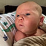 Julius joined the competition — help win amazing prizes! baby, blanket, cheek, child, closeup, curious, dinosaur_print, expression, eyes, face, head, indoors, infant, mouth, newborn, pillow, resting, skin, soft_texture, wrapped