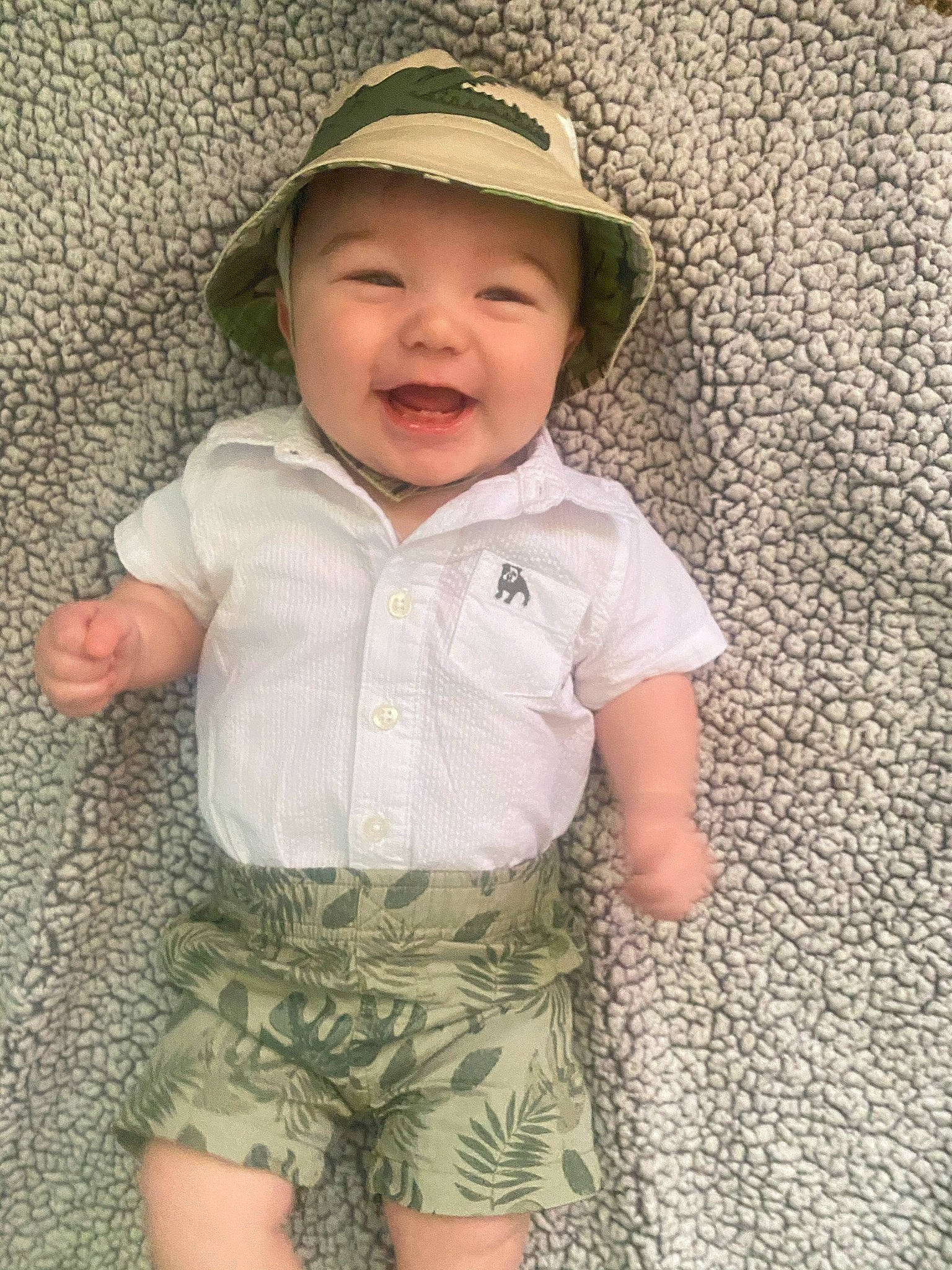 Corbin joined the competition — help win amazing prizes! baby, baby_toddler_clothing, cap, cheek, child, eye, face, facial_expression, fun, grass, happy, head, headwear, pattern, person, shorts, skin, sleeve, smile, sun_hat