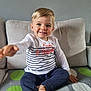 architecture, bodypart, boy, child, clothing, couch, cushion, face, finger, furniture, hand, head, homedecor, male, pants, person, photography, portrait, sitting, t_shirt