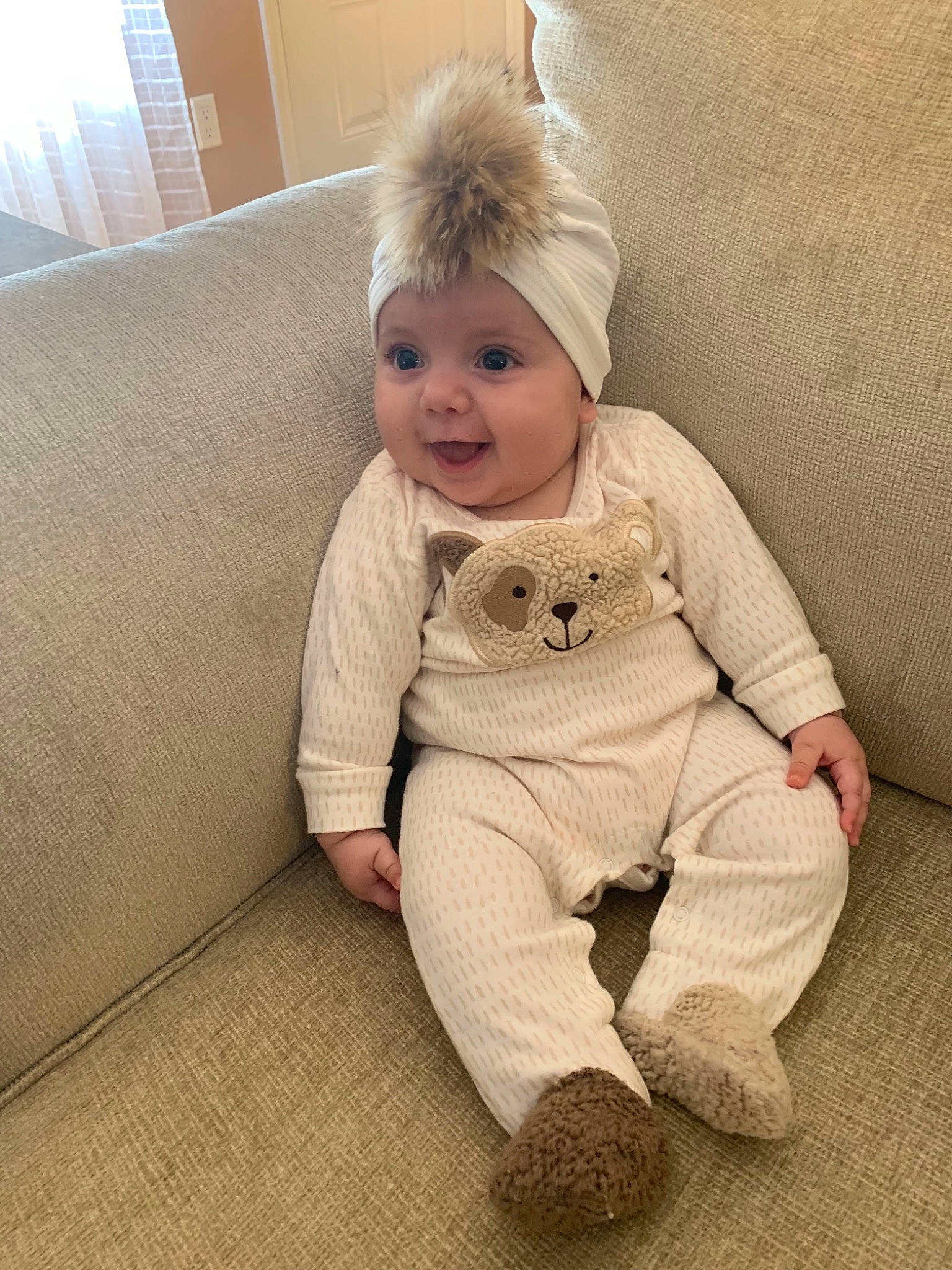 Lina is registered to the contest to win money with this photo: baby, blond, cheek, child, ear, eye, face, fawn, floor, fur, head, joint, leg, nose, organ, person, sitting, skin, sleeve, smile