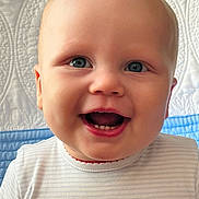 Stetson joined the competition — help win amazing prizes! baby, smiling, face, blue_eyes, teeth, striped_shirt, lobster_emblem, quilt, background, close_up, child, happy, cute, infant, portrait, person, head, apparel, indoor, expression