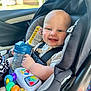 Stetson joined the competition — help win amazing prizes! baby, car_seat, child, toy, sippy_cup, smile, blue, seatbelt, indoor, person, infant, happy, plastic, car, window, colorful, clothing, face, closeup, sitting