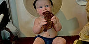 Stetson is registered to the contest to win money with this photo: baby, cowboy_hat, boots, meat, sitting, furry_rug, blue_eyes, indoor, stuffed_animal, rocking_horse, curious, cute, child, western_theme, plate, bare_chest, denim_shorts, footwear, happy, portrait
