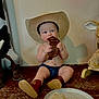 baby, cowboy_hat, boots, meat, sitting, furry_rug, blue_eyes, indoor, stuffed_animal, rocking_horse, curious, cute, child, western_theme, plate, bare_chest, denim_shorts, footwear, happy, portrait