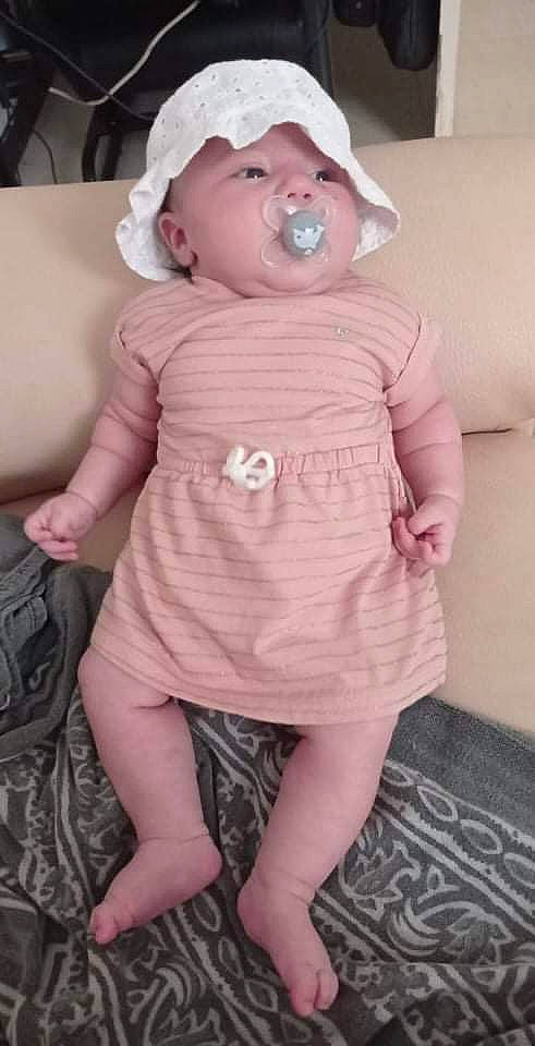 Madyson participe au concours pour gagner de l'argent avec cette photo : arm, baby, baby_toddler_clothing, cheek, dress, eye, head, headgear, headwear, human_leg, knee, lip, mouth, nose, person, pink, skin, sleeve, textile, thigh
