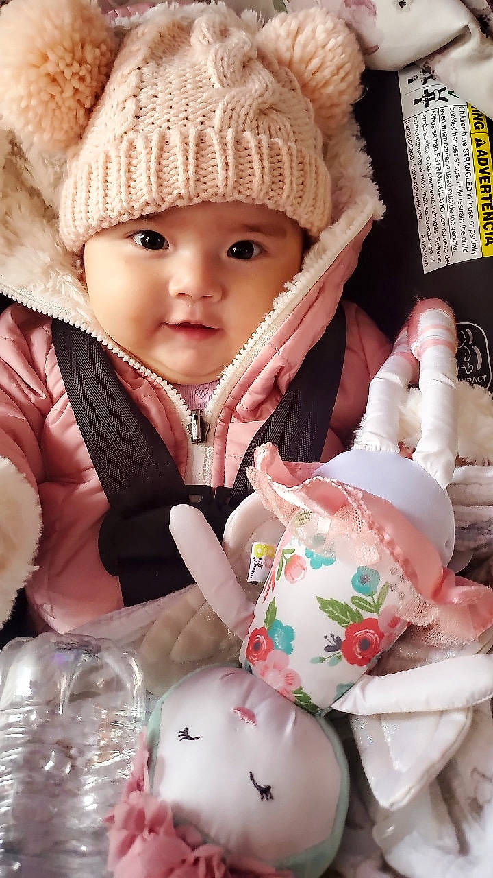 Annie joined the competition — help win amazing prizes! baby, baby_toddler_clothing, cap, cheek, child, comfort, drinkware, eye, fashion_accessory, headwear, knit_cap, person, pink, serveware, skin, sleeve, tableware, textile, toddler, white