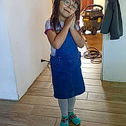 Madison a rejoint le concours — aidez-le/la à gagner de superbes lots ! child, girl, glasses, blue_dress, socks, indoor, wooden_floor, vacuum_cleaner, door, curtain, smiling, posing, long_hair, casual_clothing, home, floor_tiles, wall, cozy, happy, young