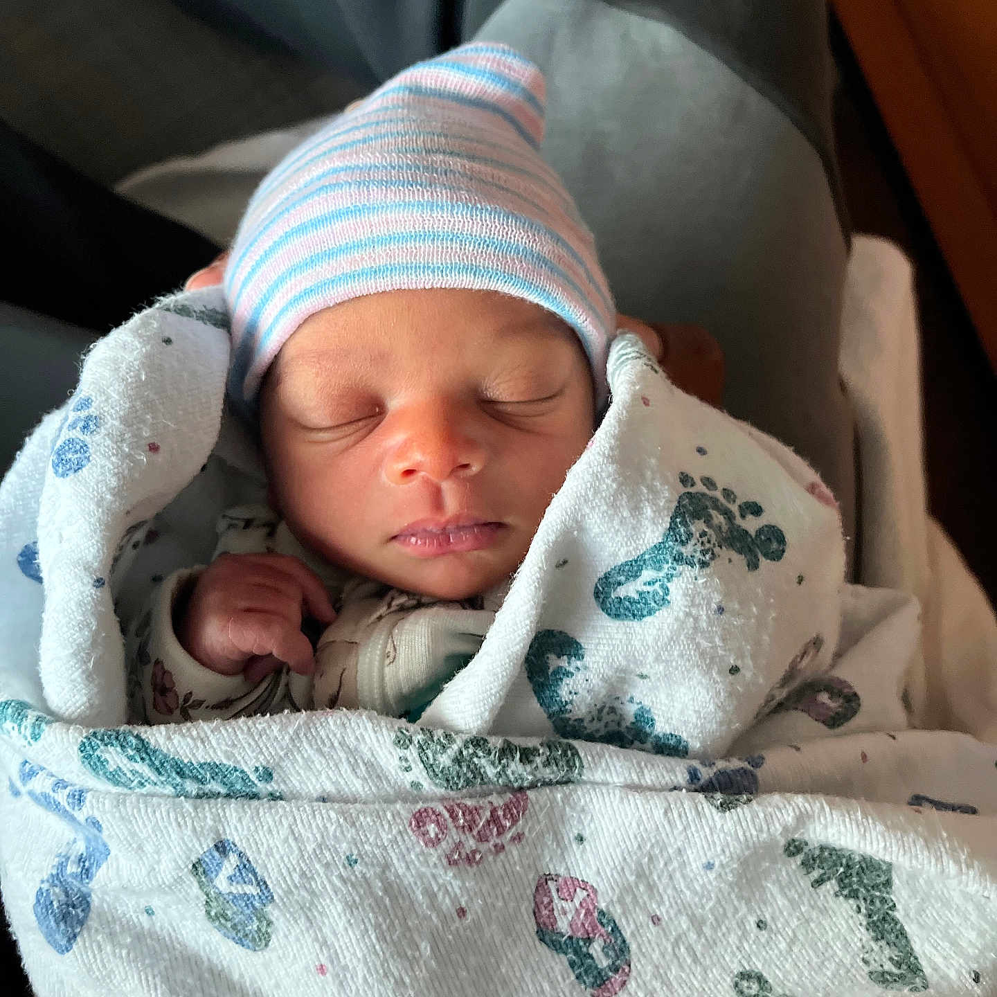 Keisha is registered to the contest to win money with this photo: newborn, baby, sleeping, blanket, hospital, cap, infant, wrapped, peaceful, person, hand, cute, soft, cozy, portrait, closeup, child, resting, indoors, newborn_baby