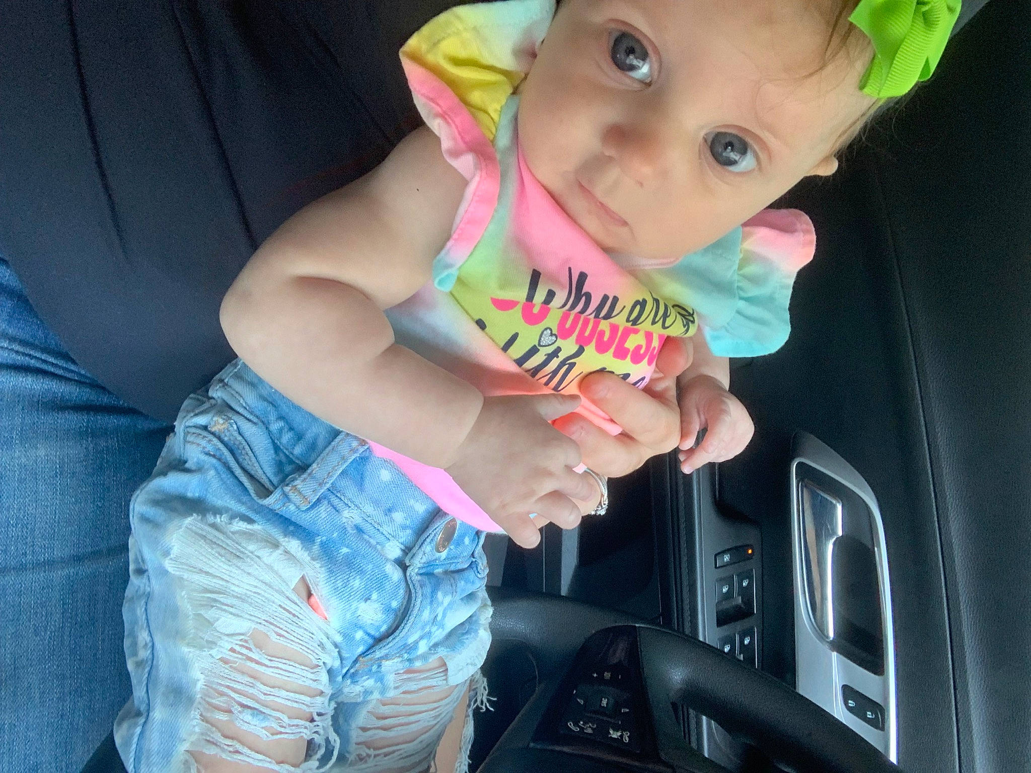 Willow is registered to the contest to win money with this photo: auto_part, automotive_exterior, baby, baby_toddler_clothing, car, car_seat, cool, finger, fun, gesture, happy, hat, human_body, motor_vehicle, mouth, person, steering_wheel, thumb, toddler, vehicle