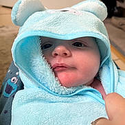 Vinnie joined the competition — help win amazing prizes! baby, child, towel, blue, hood, face, hand, cute, cozy, soft, plush, indoor, person, infant, wrapped, closeup, skin, expression, apparel, comfort