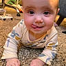 baby, child, crawling, drool, tongue, carpet, onesie, indoor, cute, playful, face, hands, floor, infant, person, young_child, expression, home, furniture, background