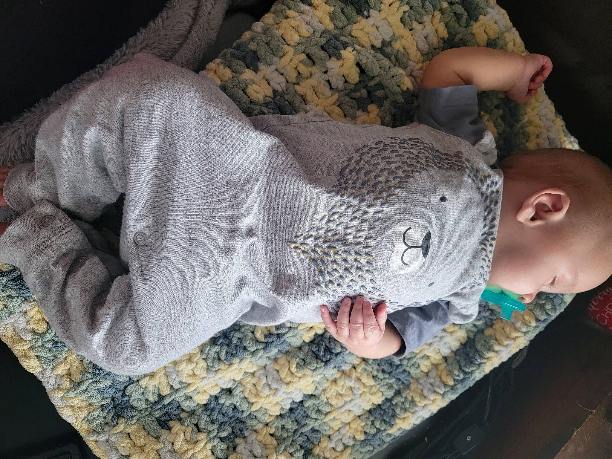 Carter is registered to the contest to win money with this photo: baby, baby_products, baby_toddler_clothing, child, comfort, elbow, finger, fur, gesture, grey, linens, nail, pattern, person, sitting, sleeve, textile, thread, wool, woolen