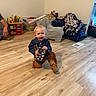 baby, child, toddler, cowboy_costume, denim_jacket, hat, boots, toy_phone, smiling, indoor, playroom, wood_floor, toys, blankets, cushions, furniture, portrait, sitting, crouching, home