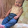 Millie is registered to the contest to win money with this photo: baby, infant, smiling, happy, clothing, blue_pants, pink_top, blanket, quilt, couch, barefoot, relaxing, indoors, child, person, cute, comfortable, soft_texture, home, portrait