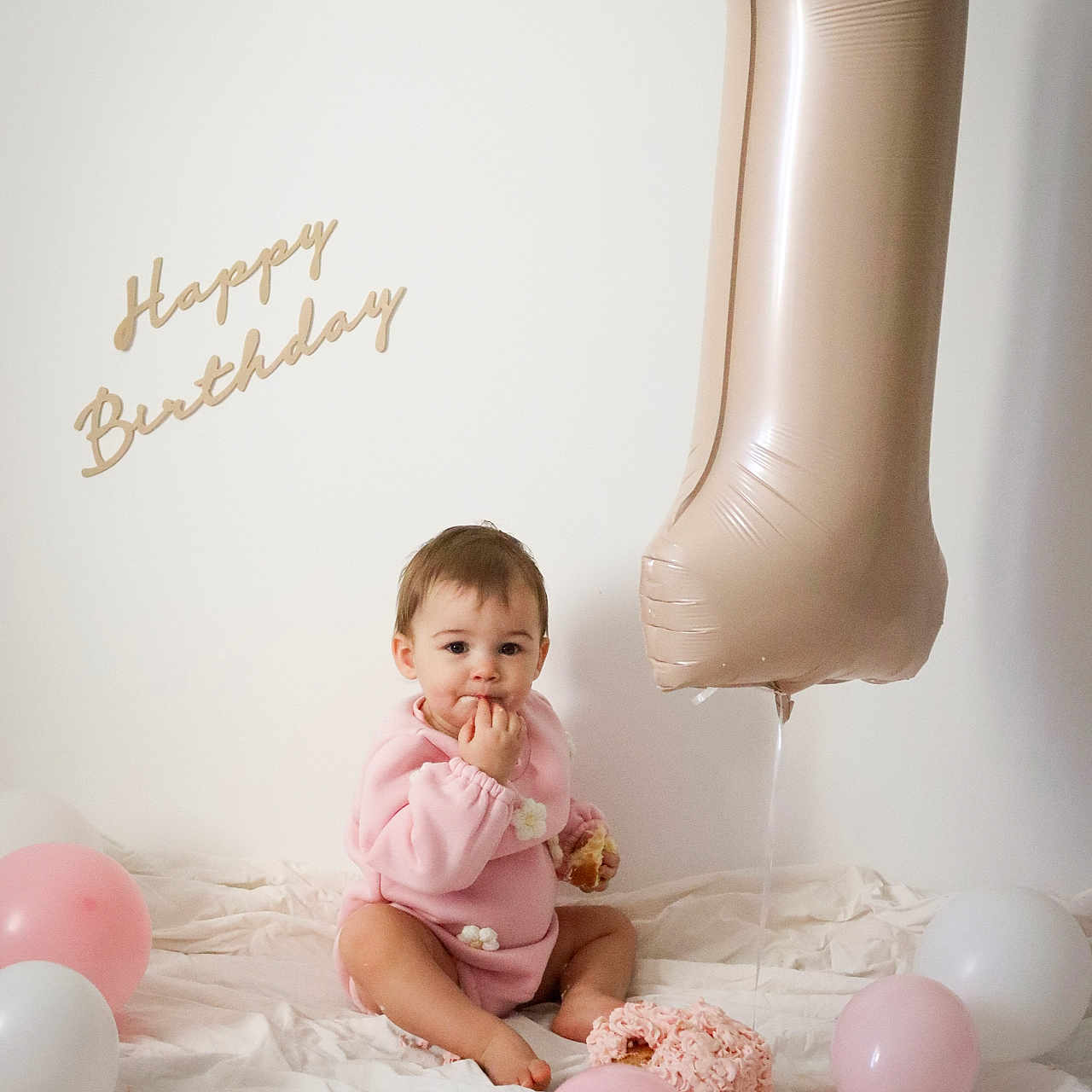 Lya participe au concours pour gagner de l'argent avec cette photo : baby, balloon, bodypart, clothing, cream, dessert, dress, face, finger, furniture, hand, head, indoors, people, person, photography, portrait, sitting, sphere, text