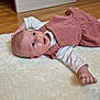 Iris a rejoint le concours — aidez-le/la à gagner de superbes lots ! baby, blue_eyes, child, corduroy, cute, expression, fingers, floor, hand, head, indoor, infant, long_sleeve_shirt, lying_down, newborn, pink_dress, portrait, rug, skin, wooden_floor