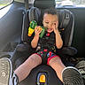 Kawhi joined the competition — help win amazing prizes! toddler, child, car_seat, toy, toy_drill, car_interior, seatbelt, smiling, curly_hair, shorts, sneakers, window, daylight, playful, happy, person, casual_clothing, seat, safety, vehicle