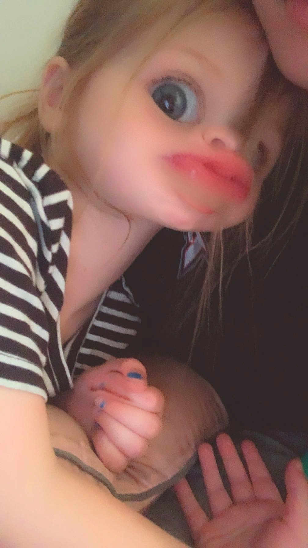Oakley is registered to the contest to win money with this photo: accessories, baby, bodypart, clothing, earring, face, finger, hand, head, jewelry, kissing, newborn, person, photography, portrait, ring, romantic, selfie, t_shirt, toy