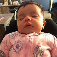 Amelia is registered to the contest to win money with this photo: newborn, baby, infant, sleeping, portrait, face, pink_onesie, floral_clothing, indoors, living_room, chair, furniture, sunlight, warm_lighting, closeup, peaceful, family_home, child, head, photograph