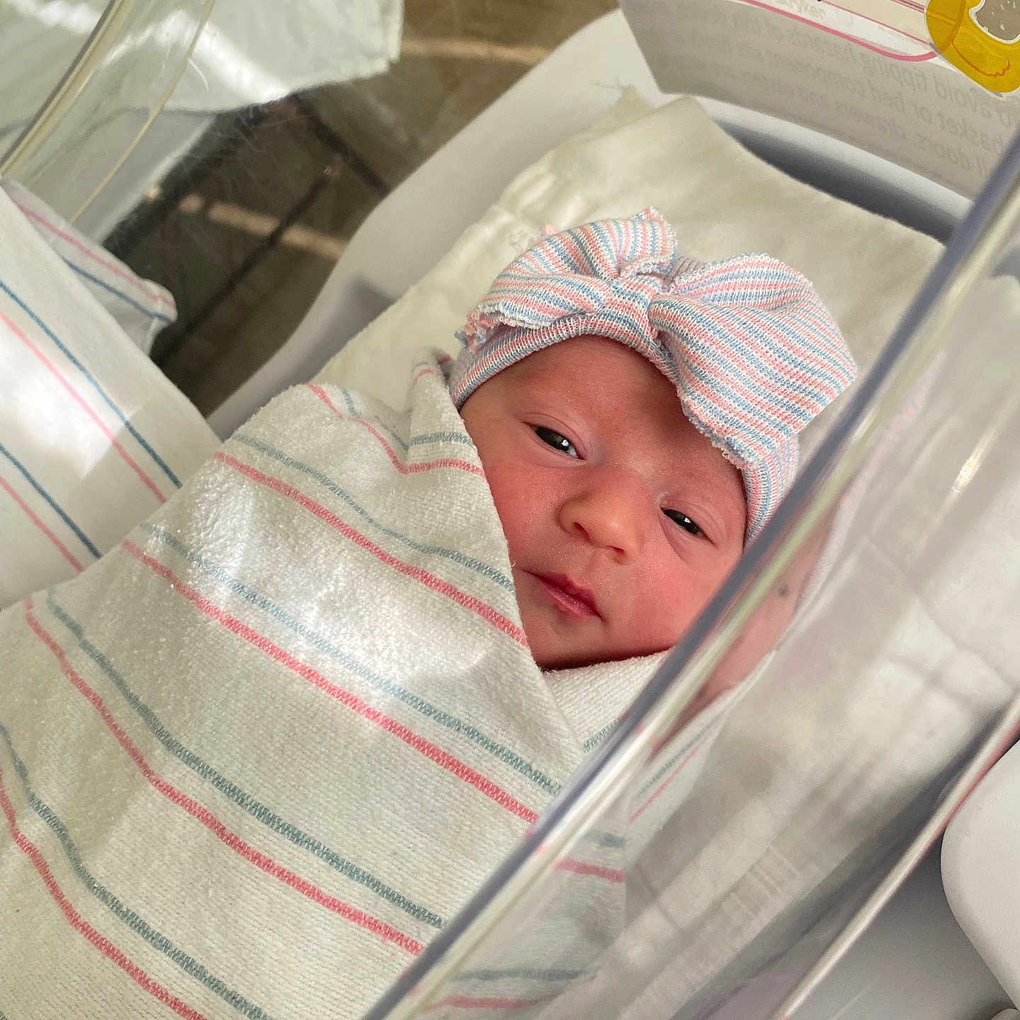 Adalynn joined the competition — help win amazing prizes! newborn, baby, hospital, blanket, bassinet, swaddled, infant, hat, striped, resting, cute, sleepy, portrait, closeup, person, bed, medical, crib, soft, wrapped