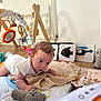 Raphaël participe au concours pour gagner de l'argent avec cette photo : baby, blanket, child, colorful, crawling, curious, early_learning, face, flashcards, floor, hands, home, indoors, infant, pajamas, playmat, stuffed_animal, toy, wooden_floor, wooden_toy_stand